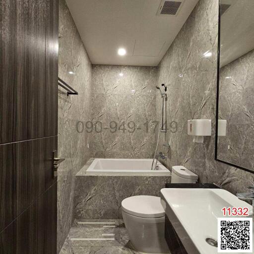 Modern bathroom with marble tiles and white fixtures