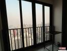 balcony with city skyline view and floor to ceiling windows