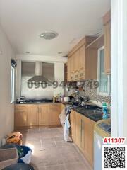 Spacious kitchen with modern appliances and wooden cabinets