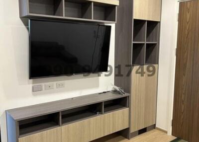 Modern living room interior with mounted television and minimalist shelving