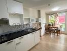 Spacious kitchen with modern appliances and dining area