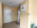 Warm-toned entryway with wooden flooring and decorative elements