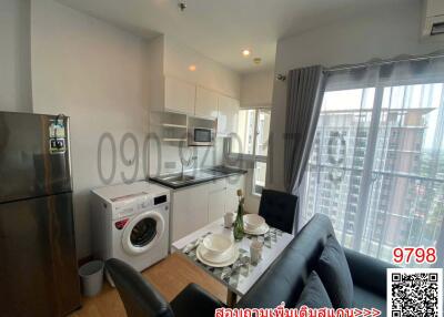 Modern living room with integrated kitchen appliances and dining area