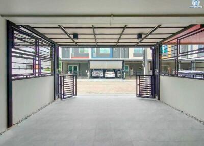 Spacious garage with tiled flooring and secured metal grilles