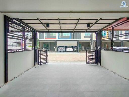 Spacious garage with tiled flooring and secured metal grilles