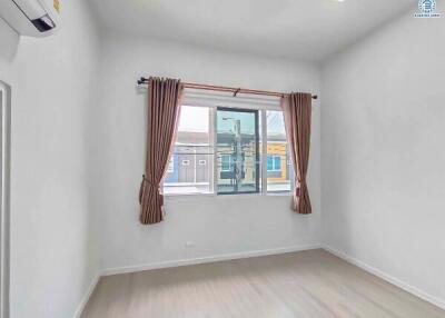 Bright and empty bedroom with a large window
