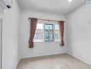 Bright and empty bedroom with a large window