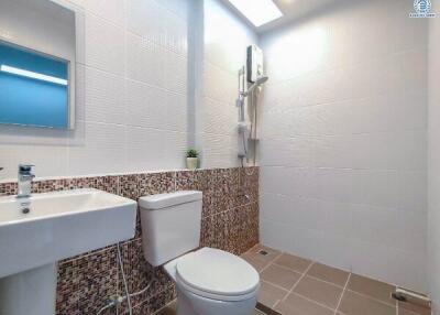 Modern bathroom with mosaic tiling and white fixtures