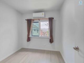 Minimalistic bedroom with large window and air conditioning unit