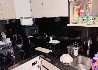 Modern kitchen with black countertops and various appliances