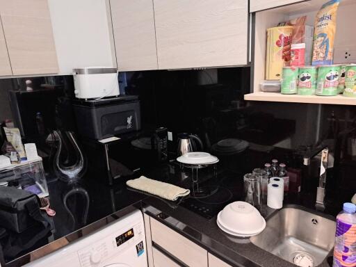 Modern kitchen with black countertops and various appliances