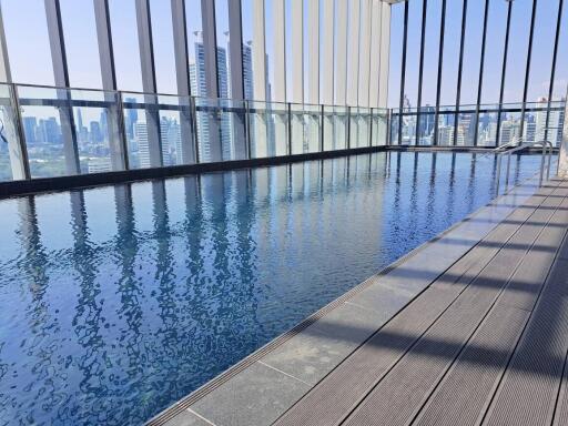 Modern rooftop swimming pool with city skyline view