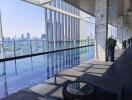 Modern balcony with infinity pool overlooking a city skyline