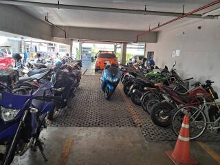 Residential parking space with multiple motorcycles and a clearance height indicator