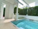 Elegant private pool with columned pergola in a residential patio