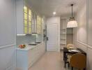 Modern kitchen with white cabinetry and built-in shelves