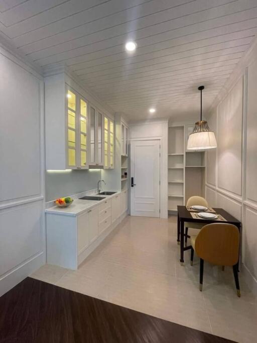 Modern kitchen with white cabinetry and built-in shelves