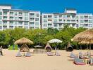 Beachfront hotel resort with lounging huts and chairs