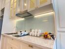 Modern kitchen with stainless steel appliances and white cabinetry