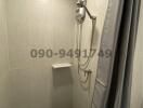 Compact bathroom with tiled walls and shower