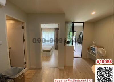 Bright living room with hardwood floors and sliding glass door leading to balcony