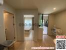 Bright living room with hardwood floors and sliding glass door leading to balcony