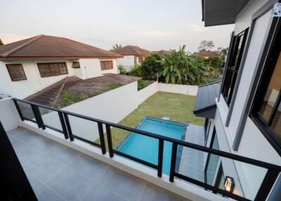 Spacious balcony with a view of a private pool and garden