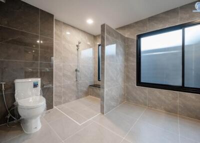 Modern bathroom with walk-in shower and wall-mounted toilet