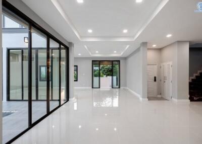 Spacious modern hallway with glossy tiled floors and ample natural light