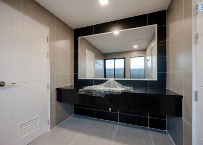 Modern bathroom interior with large mirror and black countertop