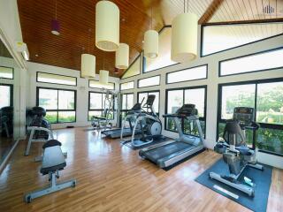 Spacious home gym with modern equipment and large windows