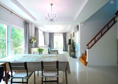 Spacious and bright living room with dining area and staircase