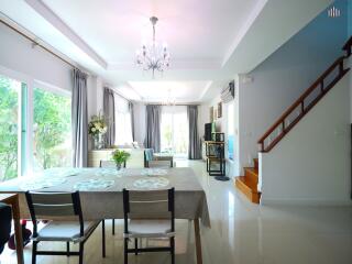 Spacious and bright living room with dining area and staircase