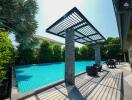 Luxurious private swimming pool with sun loungers and shaded area