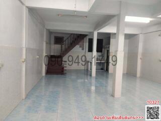 Spacious interior of a building with tiled flooring and staircase