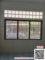 Interior view of a room with large window and decorative grills