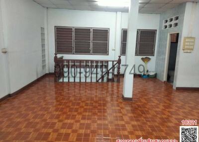 Spacious living room with tiled flooring and multiple windows