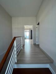 Spacious hallway leading to rooms with natural light