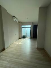 Spacious bedroom with natural light and balcony access