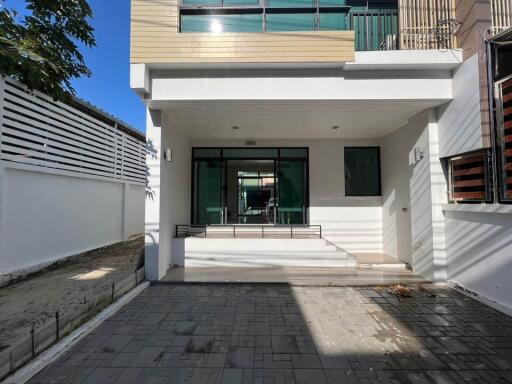 Modern two-story building with front entrance and paved driveway