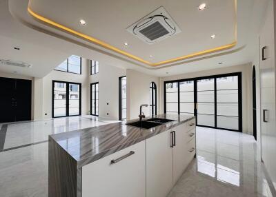 Modern kitchen with spacious design, marble floors and LED ceiling lights