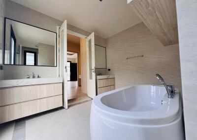 Modern bathroom with freestanding tub, double vanity, and neutral color palette