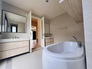 Modern bathroom with freestanding tub, double vanity, and neutral color palette