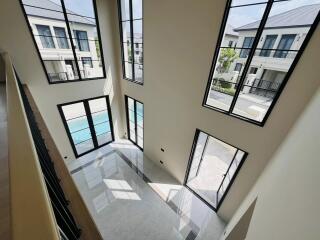 Spacious and bright high ceiling interior of a modern building with large windows