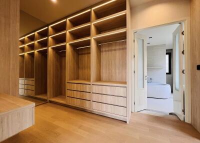 Modern Bedroom with Built-In Wooden Wardrobe and Ensuite Bathroom Entrance