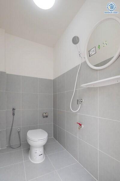 Modern bathroom with white fittings and grey tiles