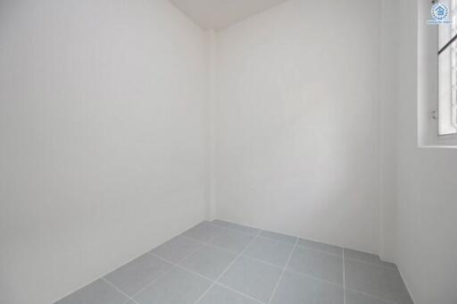 Empty interior space with white walls and tiled flooring