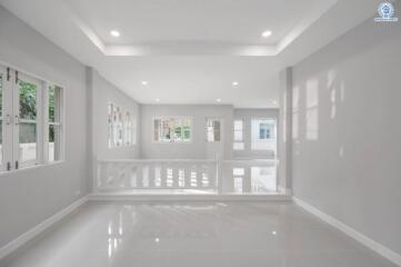 Spacious and bright unfurnished interior of a modern building with glossy white floors