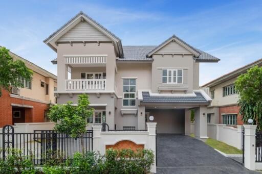 Elegant two-story residential house with a balcony and garage