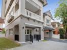 Modern two-story home with balcony and outdoor parking